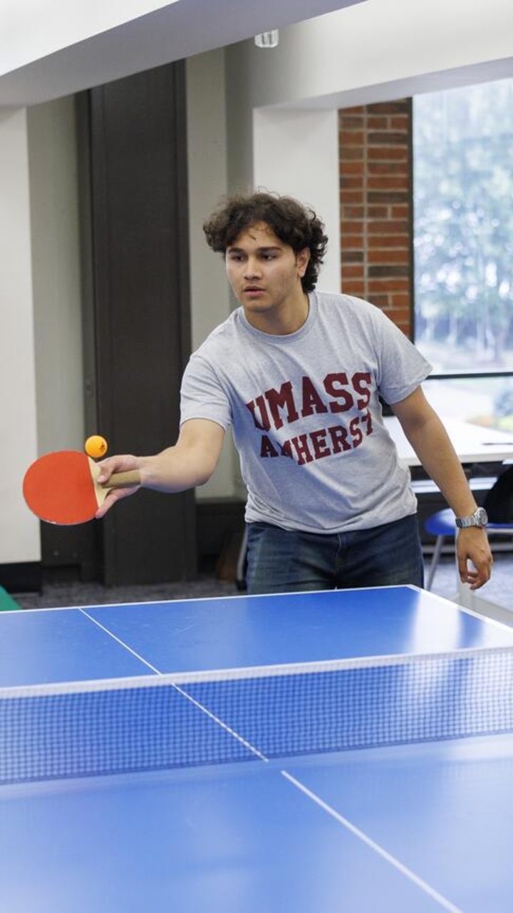 A UMass student plays ping pong.
